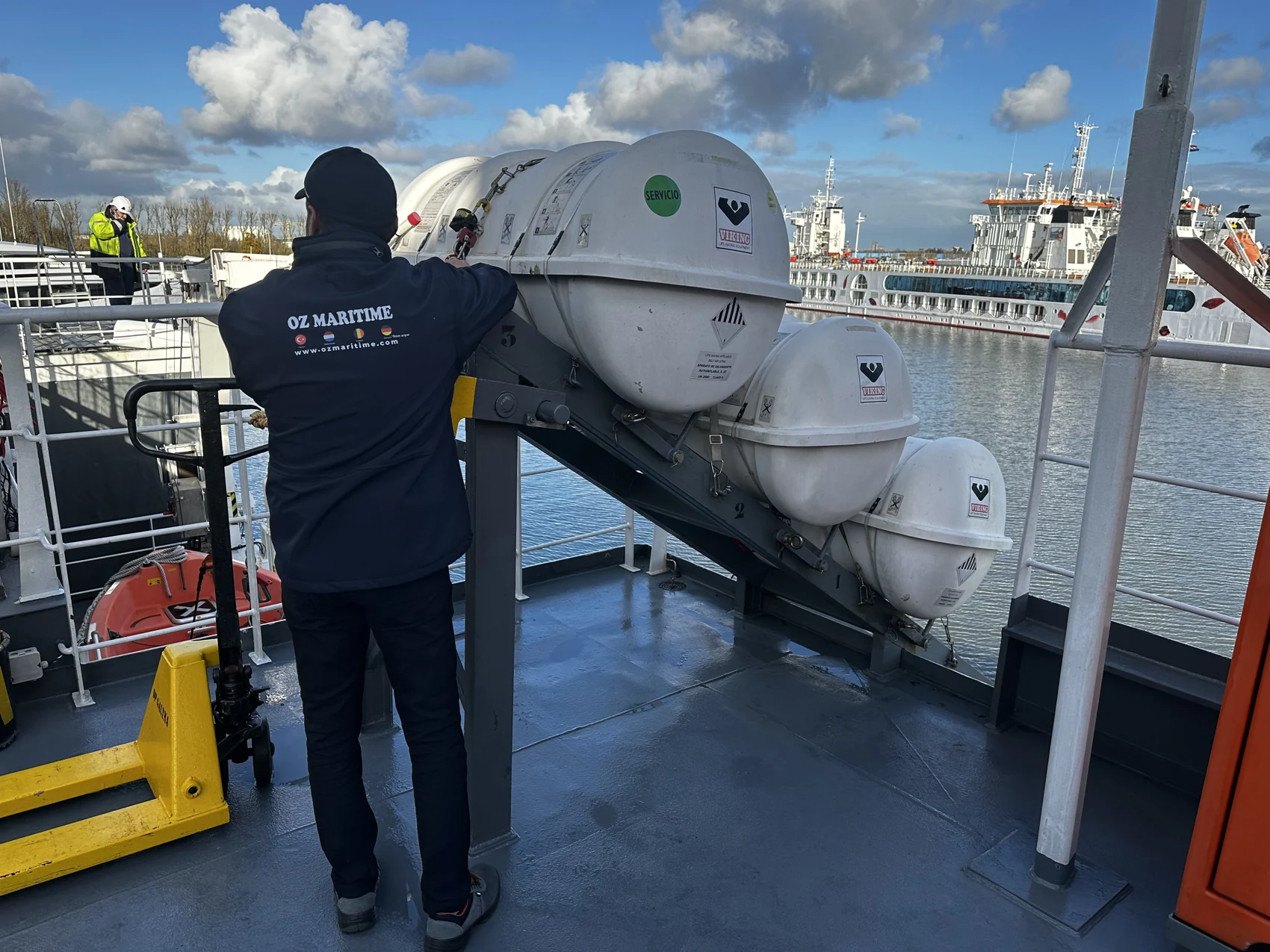 OZ Maritime technician checking a liferaft container on board