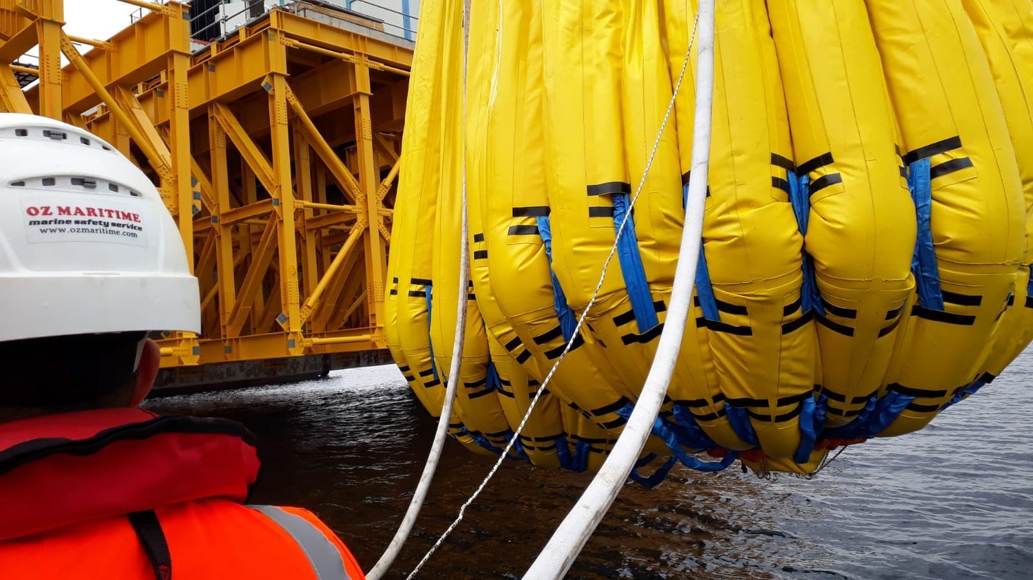 Connected water-bag test equipment alongside a vessel