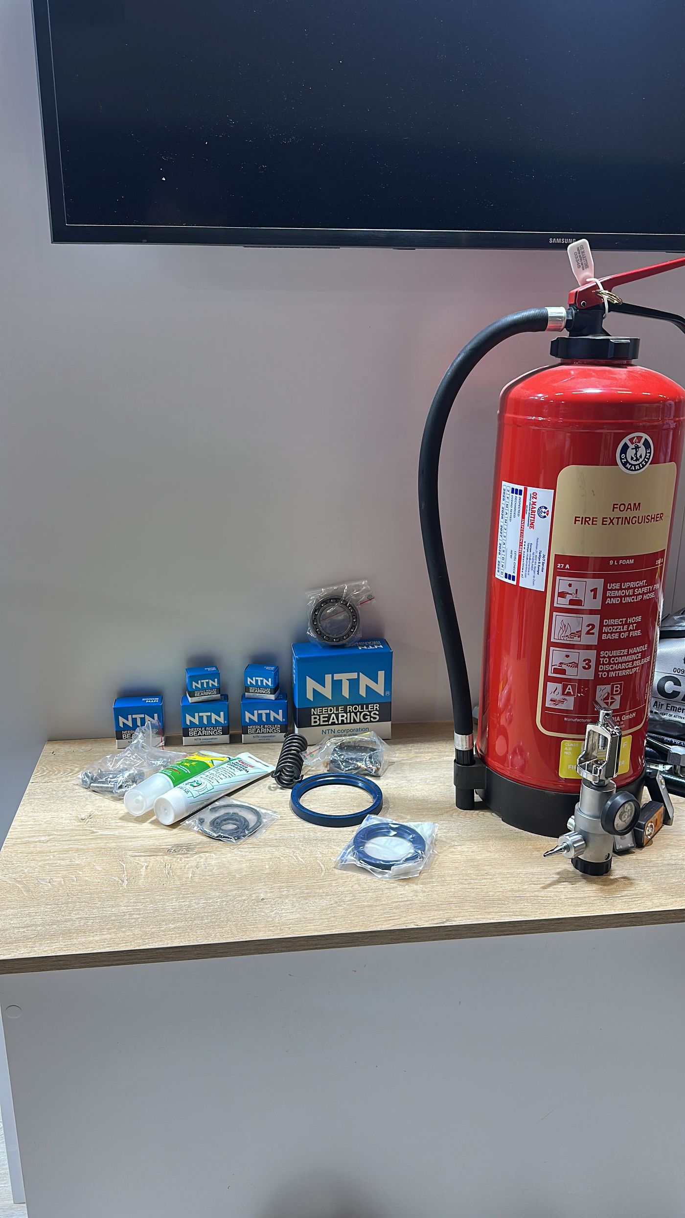 Portable extinguisher and associated marine safety components on a workbench