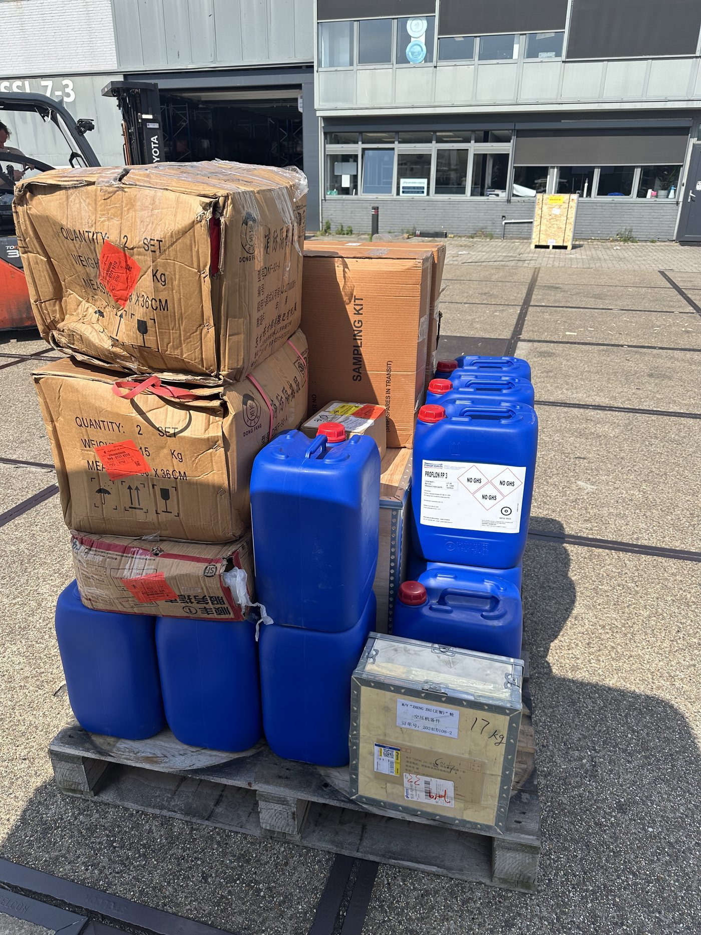 Cartons and chemical containers consolidated for vessel delivery