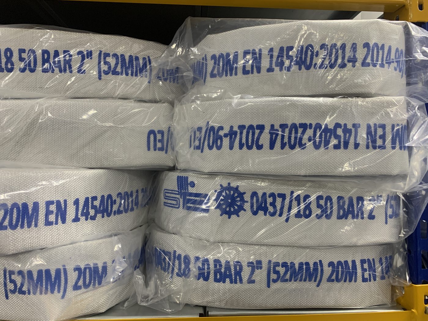 Coiled and packaged marine fire hoses