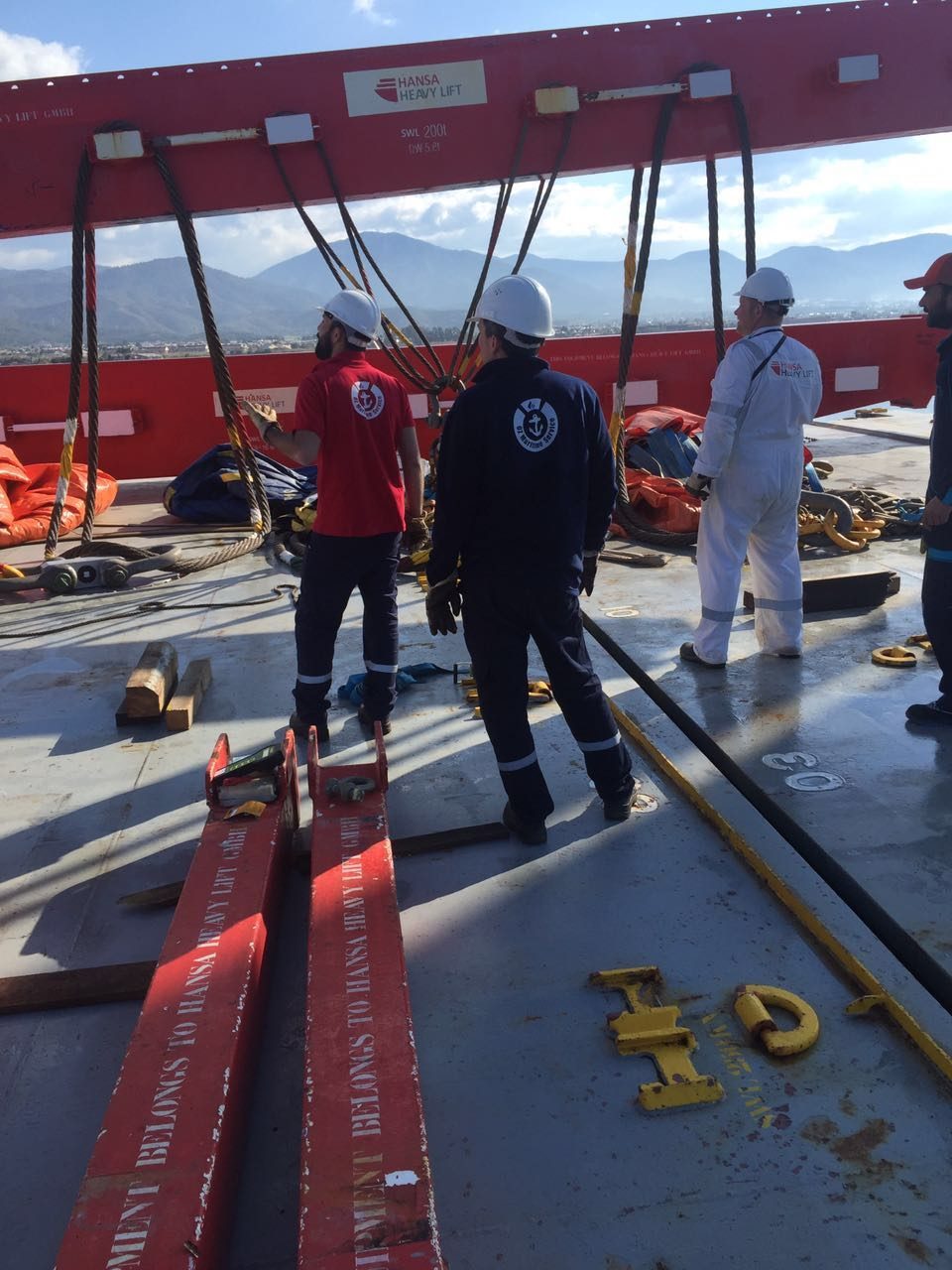 OZ Maritime colleagues preparing equipment on a vessel deck